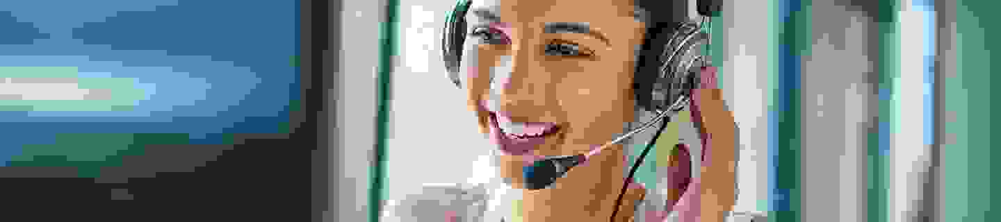 a women on a headset talking to someone laughing